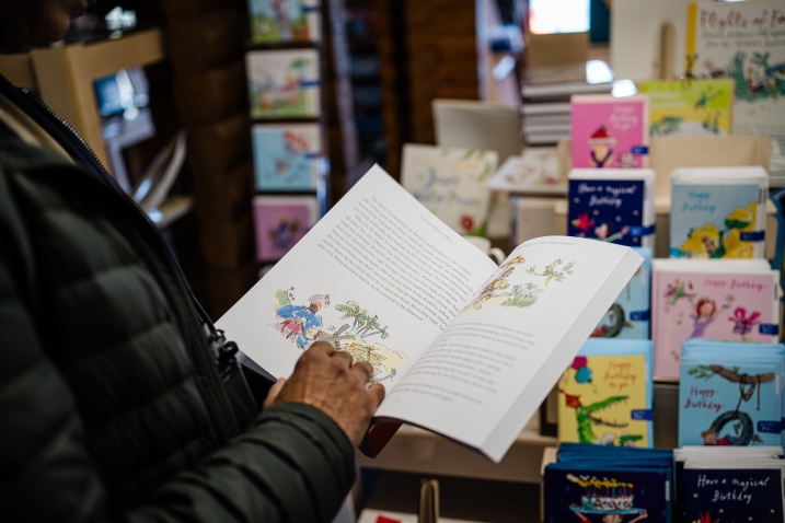 A man reading a Quentin Blake book in the WWT Martin Mere gift shop.